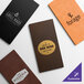 A selection of customizable slim line menu covers in various colors and textures, each featuring different restaurant logos.