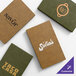 A set of customizable wicker-textured menu covers in green and brown colors, each featuring different restaurant logos.