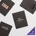 A black Menu Solutions Slim Line menu cover with a logo on it.