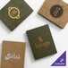 A set of four customizable wicker-textured menu covers in green and brown, each featuring different business logos and names.