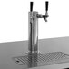 An Avantco stainless steel beer dispenser with two taps on a counter.