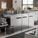 An Avantco stainless steel beer dispenser with two double tap towers on a counter.