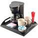 A Cal-Mil coffee amenity tray holding a coffee maker and cups.