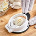 An OXO egg slicer cutting a hard boiled egg.