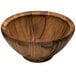 A Fox Run acacia wood salad bowl on a table.