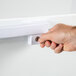 A hand holding a Galaxy key to open a door.