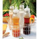 A frosted polycarbonate salad dressing bottle on a table with salad ingredients.