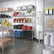 A Regency chrome wire sliding shelf in a room with shelves and shelves of food.