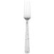 A silver Walco Vestige dinner fork with a white background.