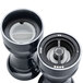 A close-up of a black and white Chef Specialties pepper mill and salt shaker set with a white lid.
