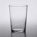 An Arcoroc customizable beverage glass on a table.