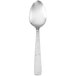 A Walco Vestige stainless steel serving spoon with a white handle.