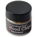 A small jar with a black lid containing wood chips for the Breville Smoking Gun.