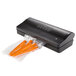 A Breville commercial vacuum packaging machine with carrots in a bag.