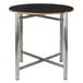 A Bon Chef round table top with a black finish on a metal base.