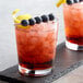 Two glasses of DaVinci blueberry cocktails with ice, blueberries, and lemon.