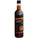 A close up of a DaVinci Gourmet Classic Gingerbread Flavoring Syrup bottle filled with brown liquid.