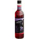 A close up of a DaVinci Gourmet Huckleberry Fruit Syrup bottle with a label. The liquid inside is purple.
