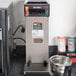 A Bunn airpot coffee brewer on a counter.