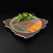 A square melamine platter with leaves on it.