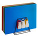 A group of colorful plastic cutting boards on a rack.