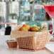 A rose gold rectangular mini fry basket filled with food on a table in a cocktail bar.