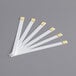 A group of white rectangular Serim 5152Q quaternary test strips with gold tips.