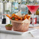 A rose gold rectangular mini fry basket filled with fries and a drink.