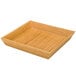 A Delfin square bamboo basket tray on a table.