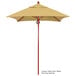A California Umbrella with a yellow Sunbrella canopy on a wooden pole.