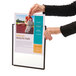 A woman's hands holding a poster with a foot print in a Durable letter sized panel.