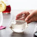 A hand holding a Chef & Sommelier Warm Tumbler filled with liquid.