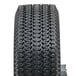 A close-up of a black Magliner hand truck tire with a tread.