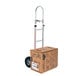 A Magliner hand truck with a cardboard box on it.