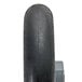 A close-up of a black Magliner balloon cushion wheel.