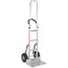 A silver Magliner hand truck with black wheels.