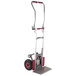 A Magliner hand truck with pneumatic wheels and a folding red handle.