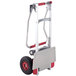 A Magliner hand truck with 10" pneumatic wheels and a folding red handle.