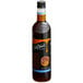 A close up of a DaVinci Gourmet Sugar Free Gingerbread Flavoring Syrup bottle full of brown liquid with a white label.