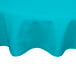 A teal Intedge round poly/cotton blend table cover on a table.