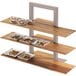 A Cal-Mil Crushed Bamboo shelf for a 3 tier frame riser holding trays of food.