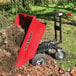 a red and black wheelbarrow with dirt in it