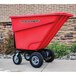 a red cart on a sidewalk