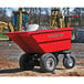 A red Magliner motorized hopper cart filled with rocks.