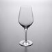 A Stolzle Exquisit Royal Bordeaux wine glass on a gray surface.