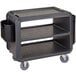 A black Cambro service cart bin with wheels.