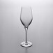 A clear Stolzle Exquisit flute wine glass on a gray surface.