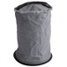 A grey cloth filter with a black circle and holes.