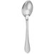A white object with a silver spoon and pointy design.