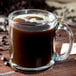 A Libbey glass mug filled with coffee beans.